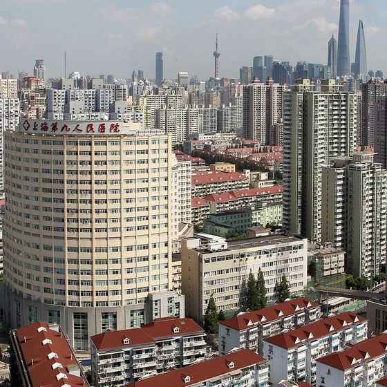 Shanghai Ninth People's Hospital (上海第九人民医院) main building with its rooftop name sign, Huangpu District, with the Lujiazui skyline behind